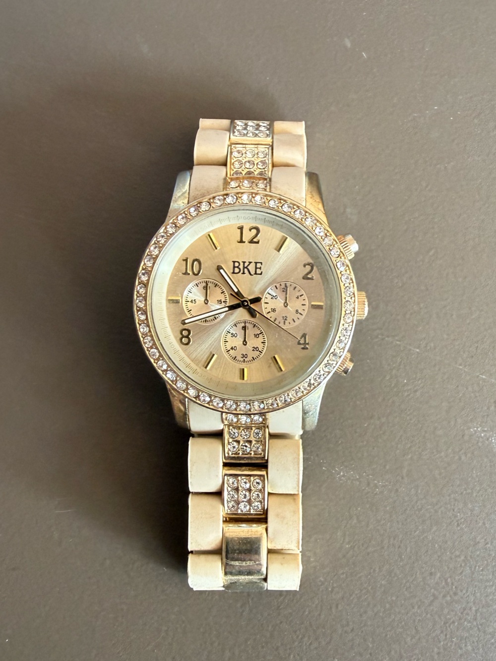 BKE Women's Gold-Tone Watch with White Ceramic-Style Band and Crystal Accents
